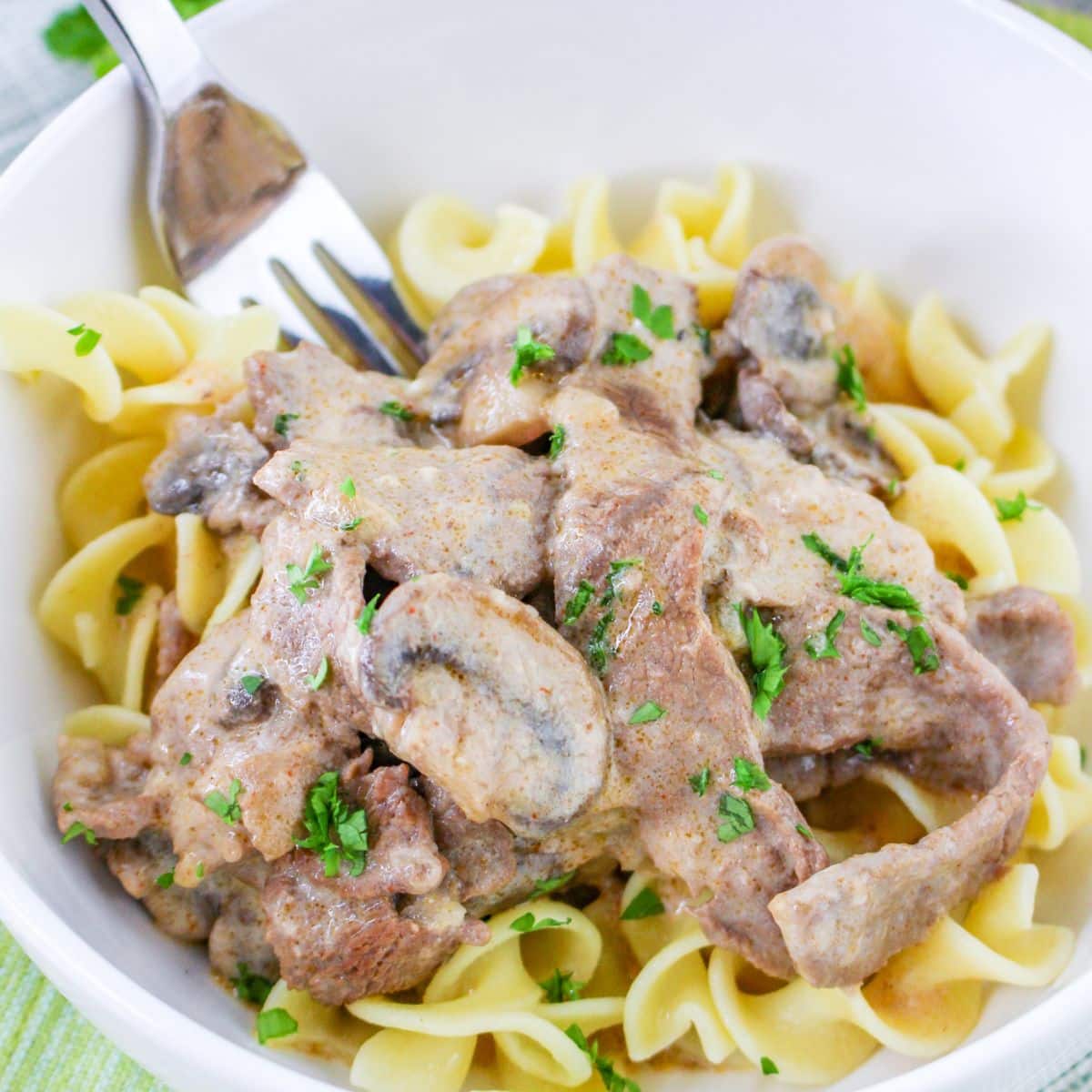 bowl full of dutch oven beef stroganoff on a table.