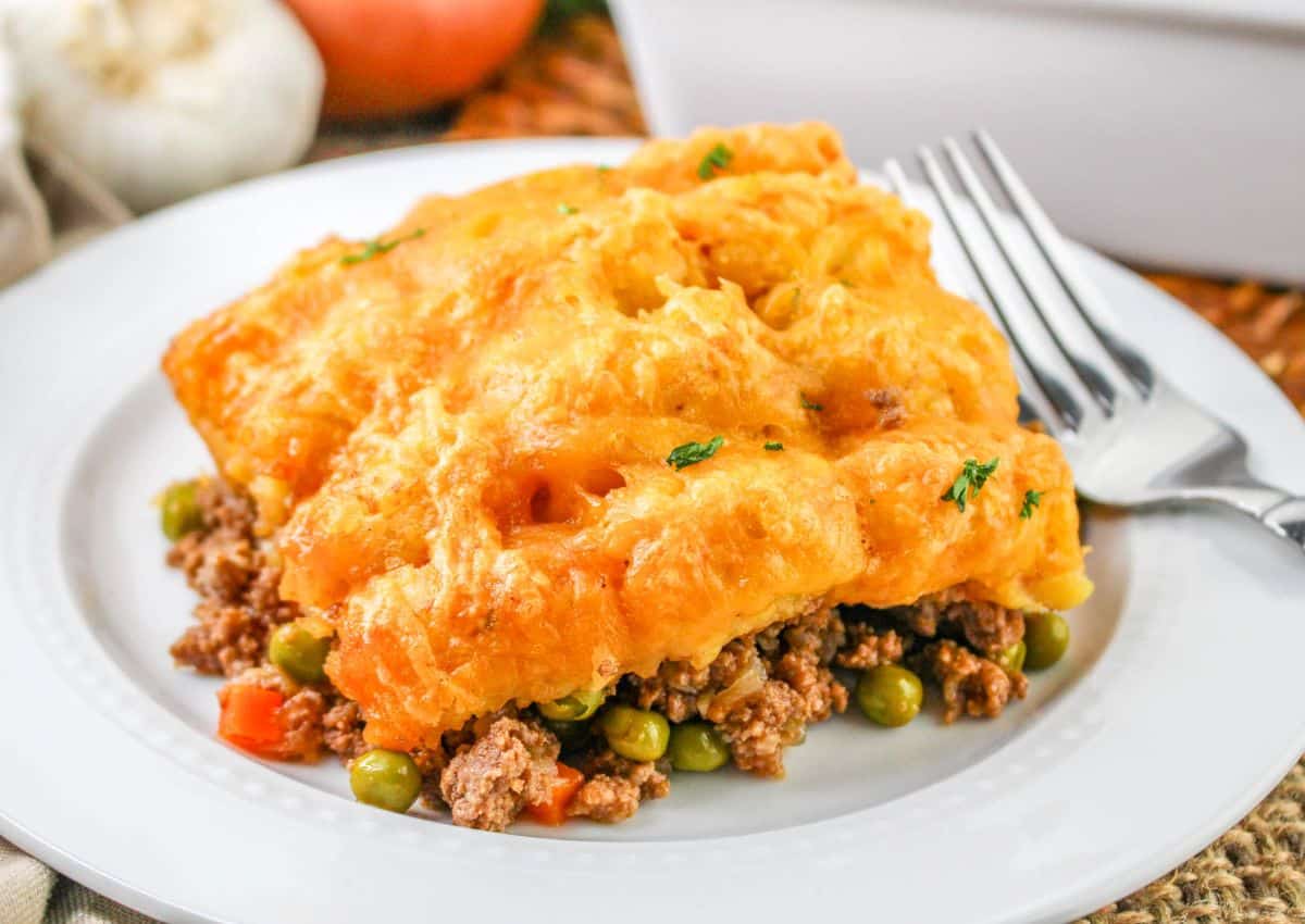 slice of shepards pie with tater tots on a plate.