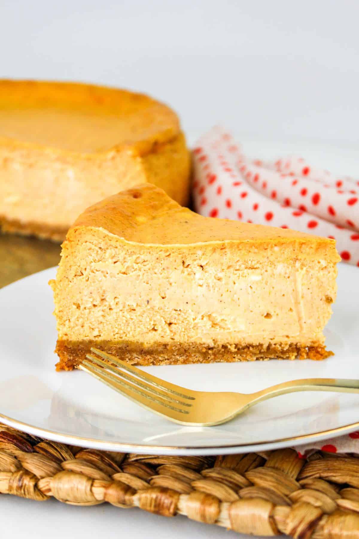 slice of Pumpkin Cheesecake on a plate with fork