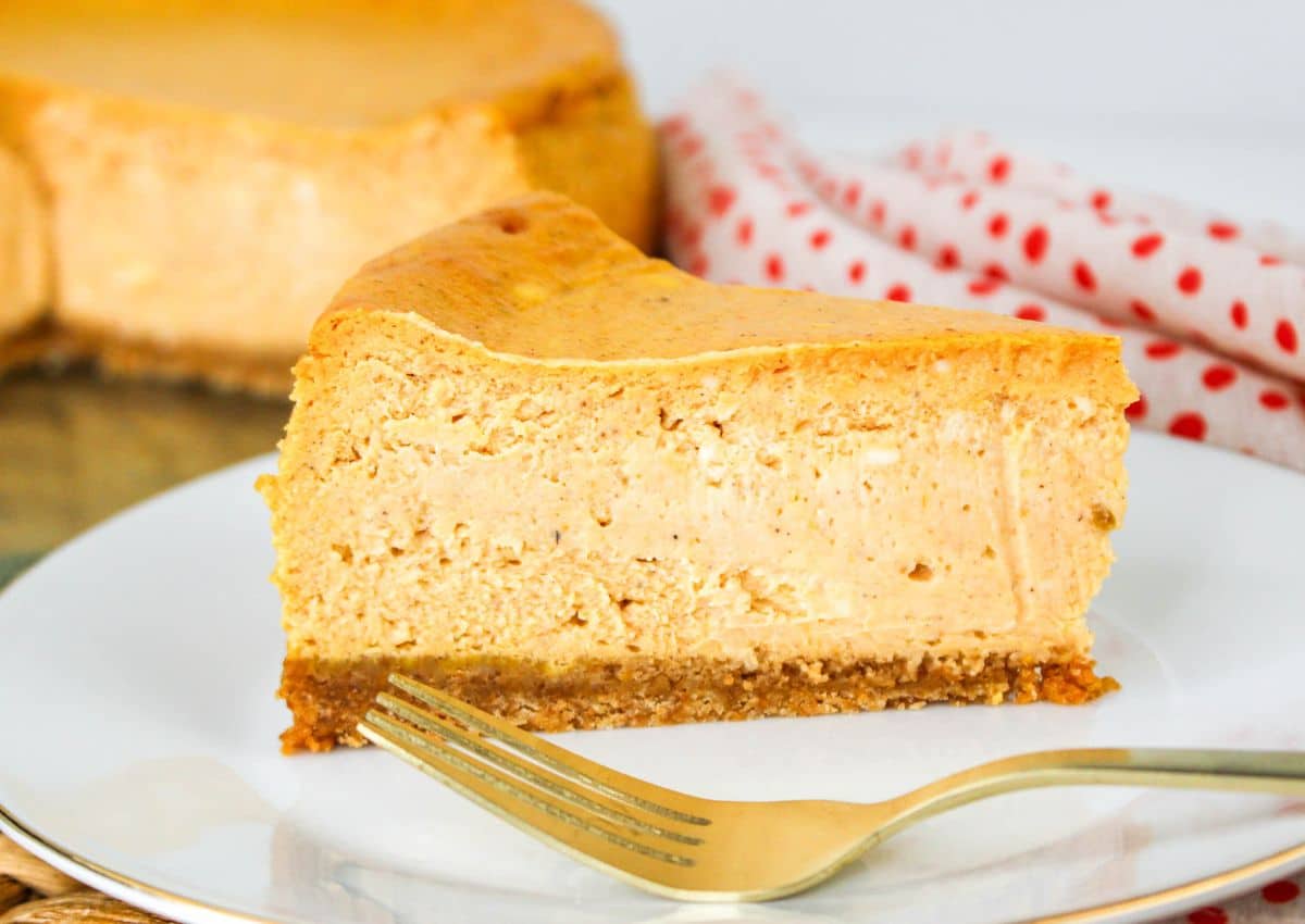 slice of Pumpkin Cheesecake on a plate with a fork