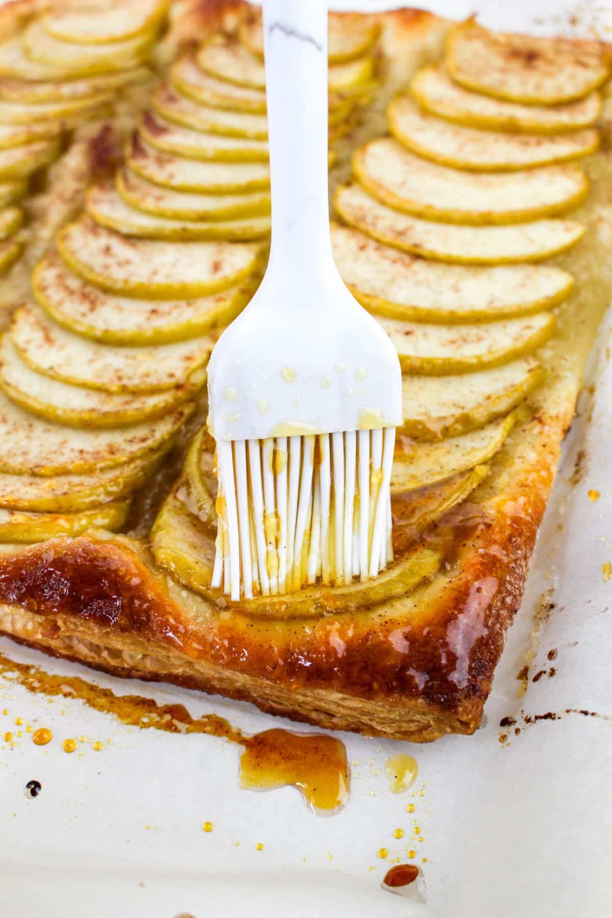 Puff Pastry with apples putting apricot jam on top