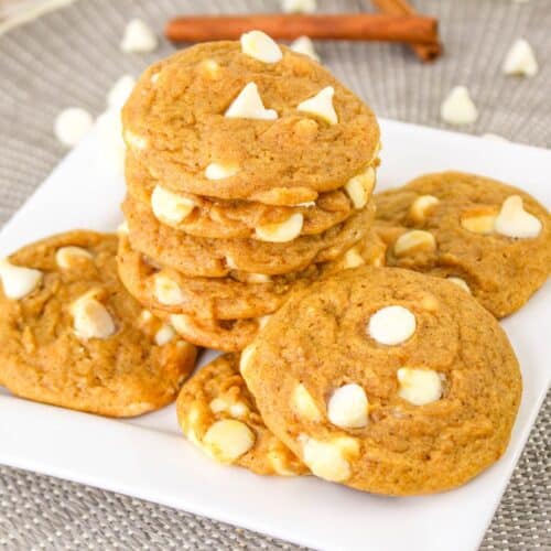 Pumpkin White Chocolate Chip Cookies on a plate stacked