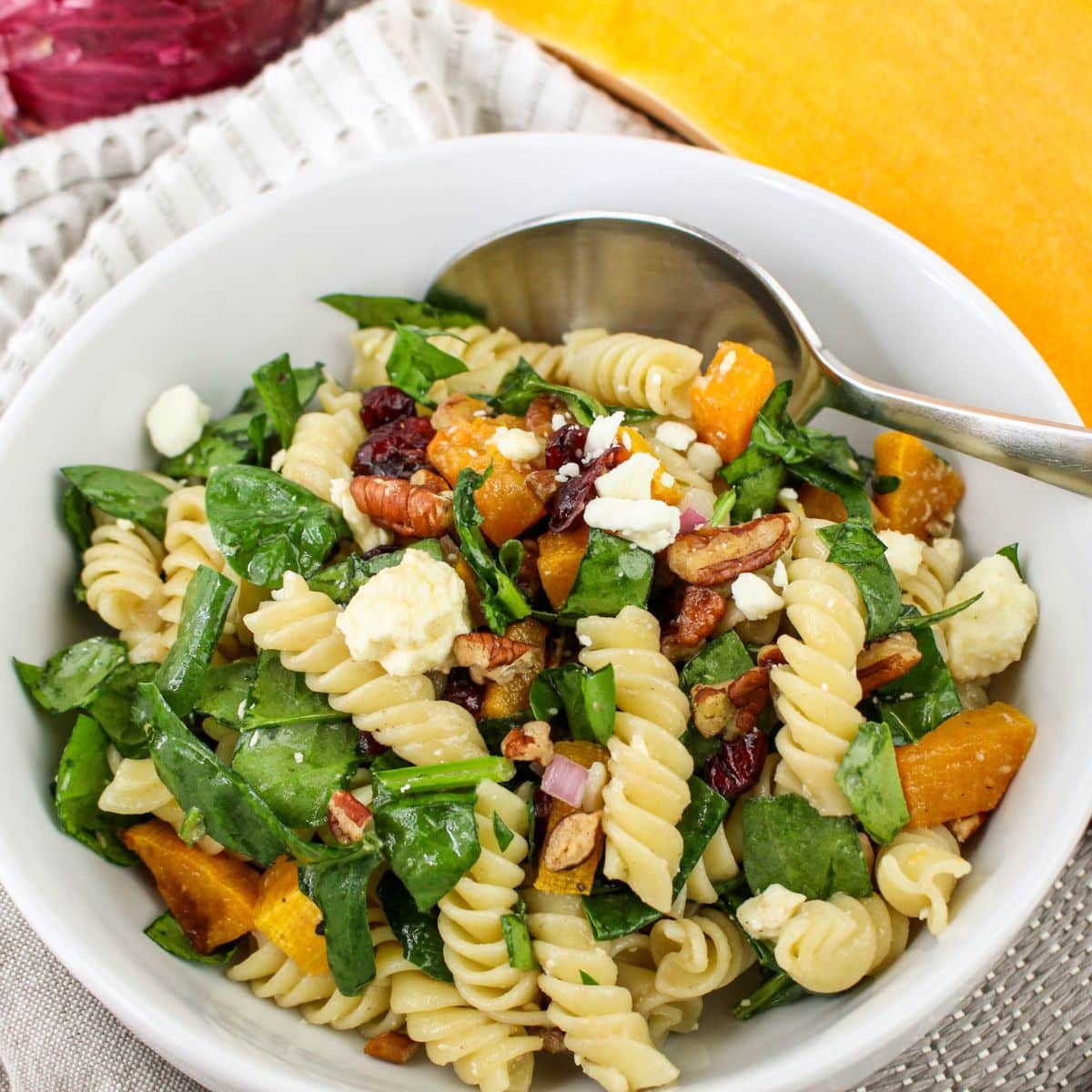 Bowl of autumn pasta salad on a table.