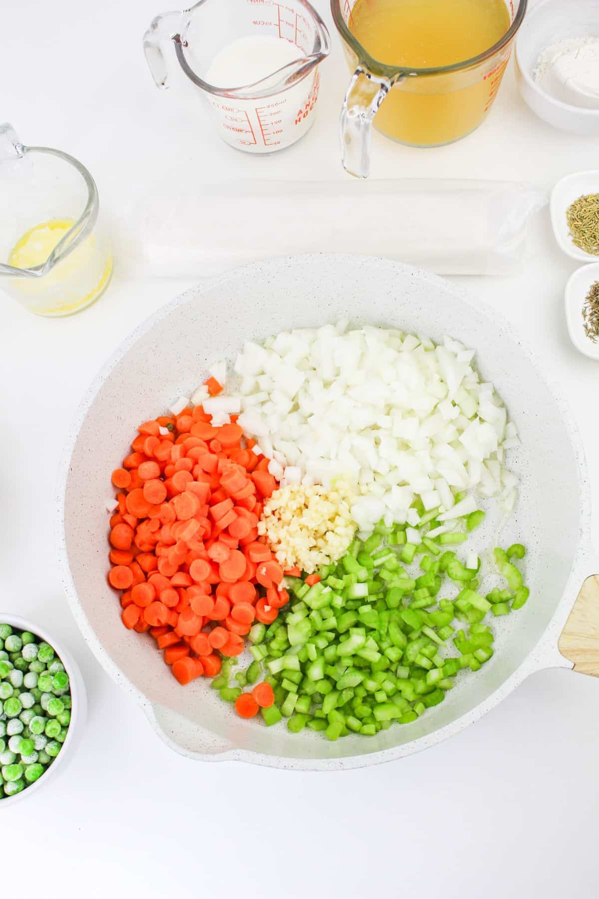 onion, carrots, celery, and garlic in pan