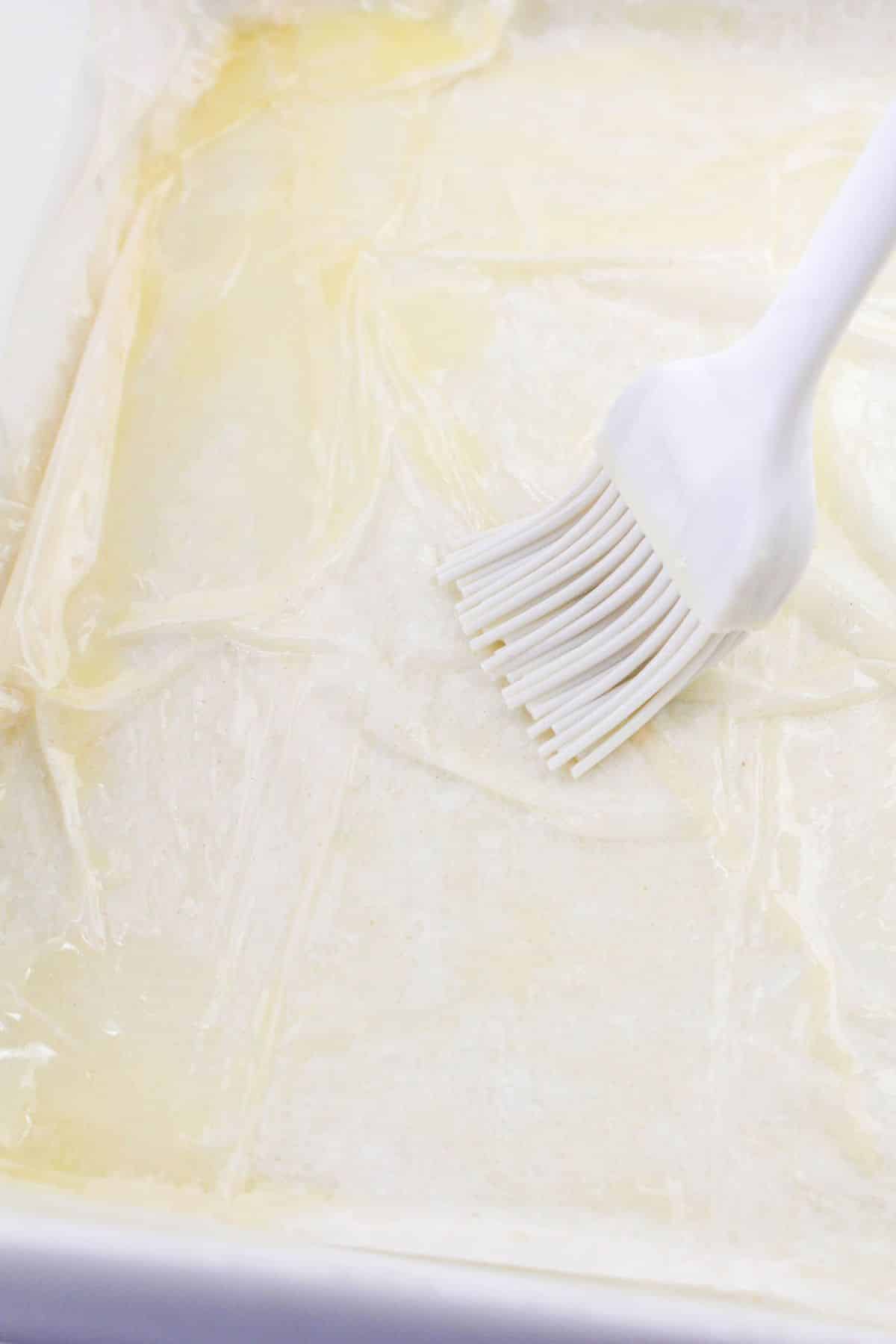 layer 5 sheets of phyllo dough, brushing each sheet with melted butter