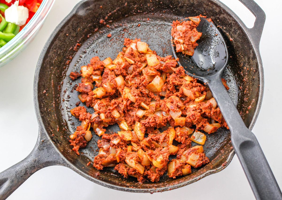 chorizo and onions cooking in skillet