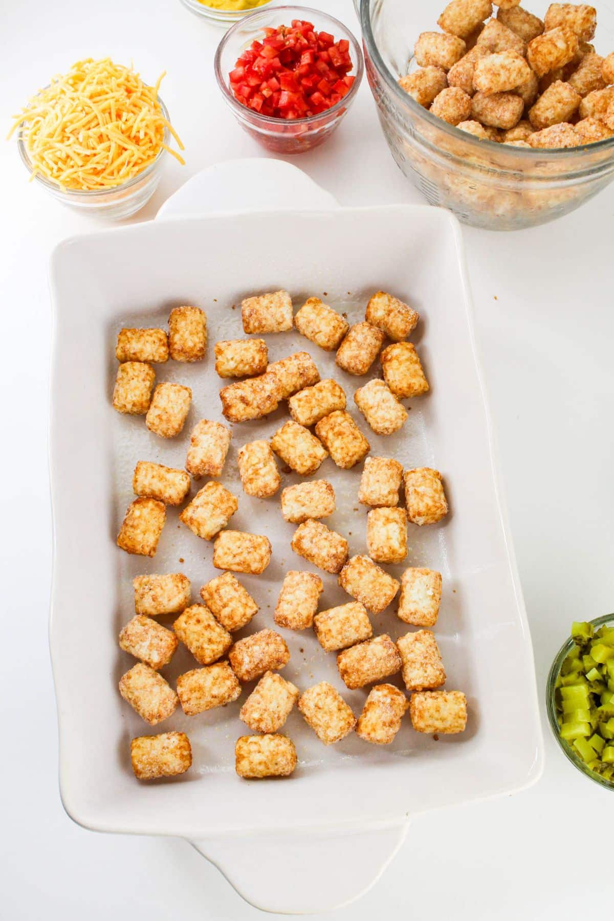 Frozen tater tots in a baking dish.