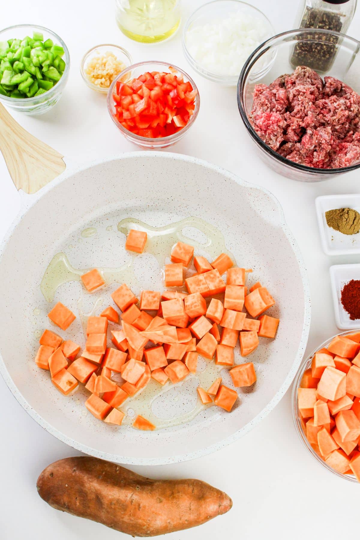 diced sweet potatoes cooking in skillet