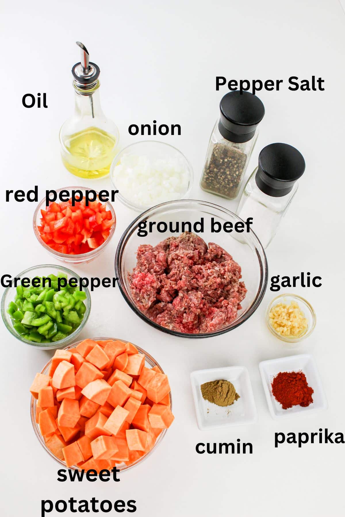 oil, salt, pepper, red pepper, green pepper, onions, ground beef, garlic, sweet potatoes, cumin, paprika