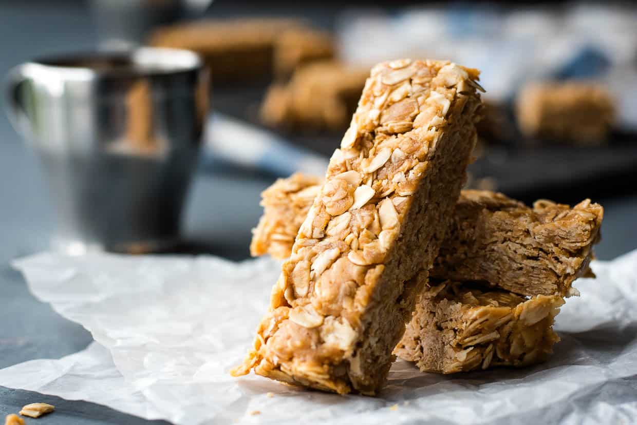 A stack of peanut butter oatmeal bars on a piece of paper.