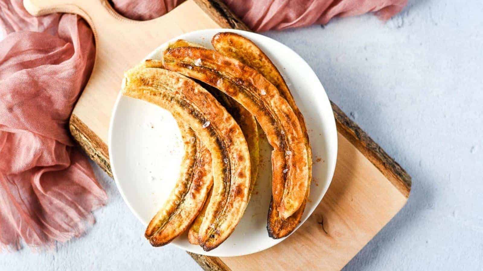 Air fryer caramelized bananas on a plate with vanilla ice cream.
