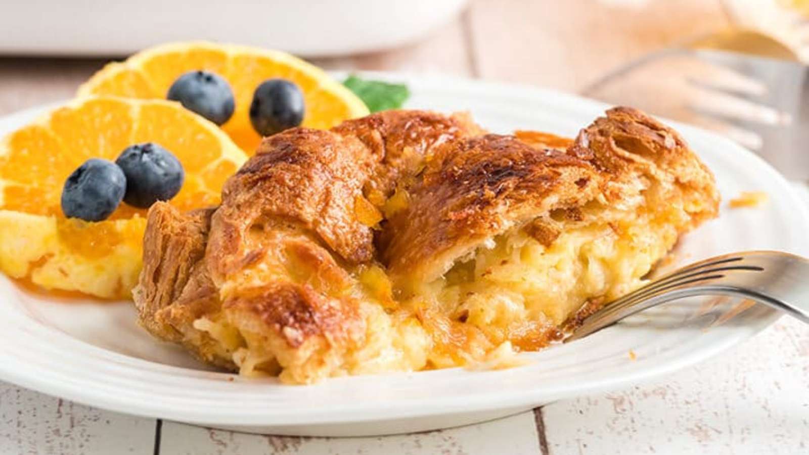 Overhead view of a croissant breakfast casserole in a skillet ready to be baked.