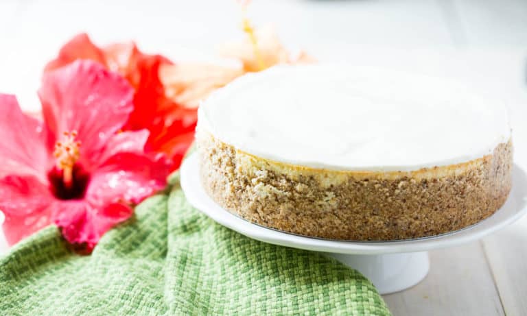 Keto Instant Pot Cheesecake on a white plate with a fork.