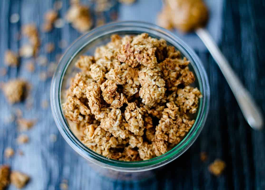 Overhead image of peanut butter granola in a jar.