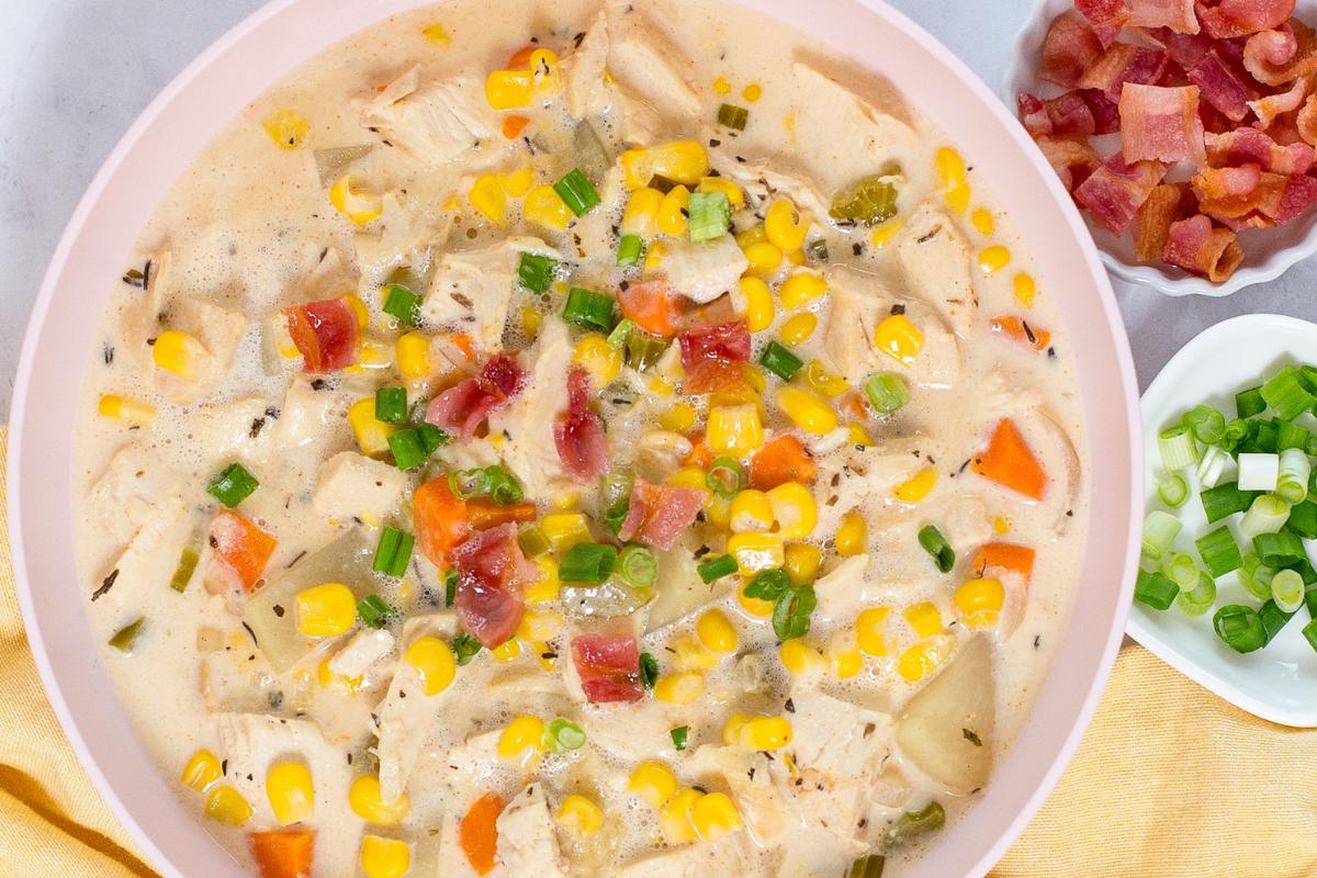 A bowl of creamy crock pot chicken corn soup with a rich, creamy texture.