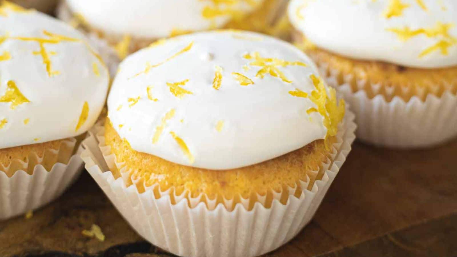 Meringue Lemon Curd Cupcakes on a wooden board.