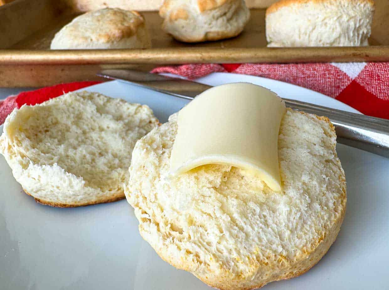 A biscuit with butter melting on it.