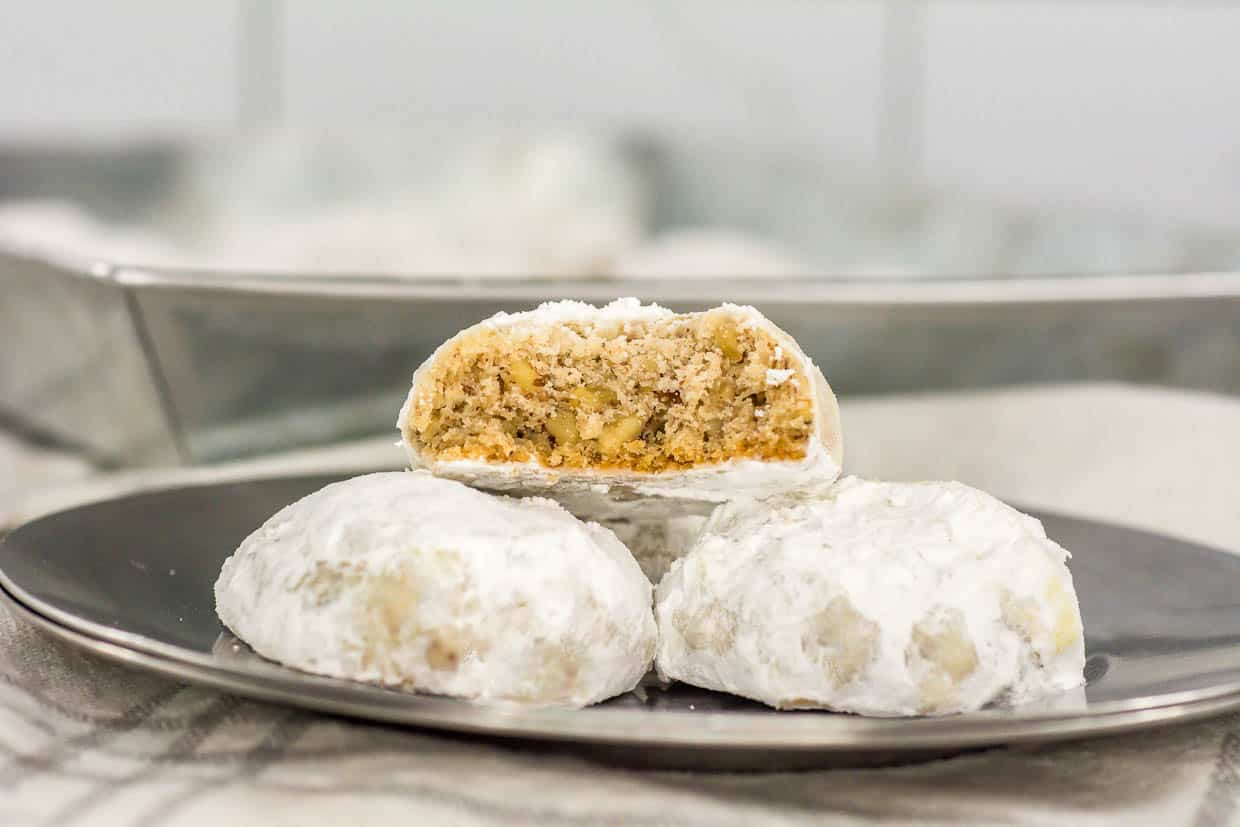 A plate of cookies with a bite taken out of them.