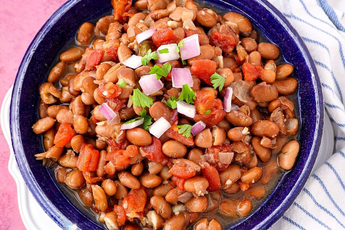 A bowl of crock pot pinto beans with a rich, hearty texture.