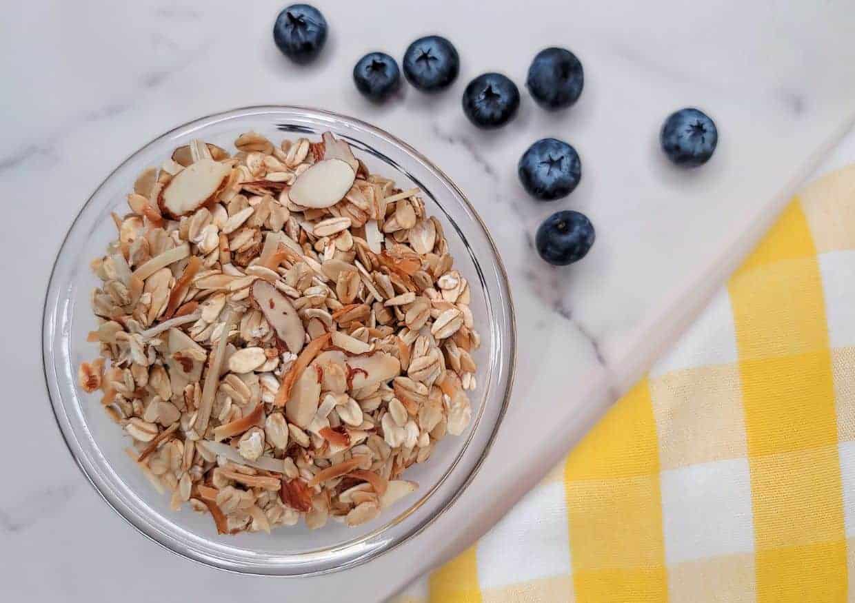 A bowl of homemade granola with fresh blueberries.