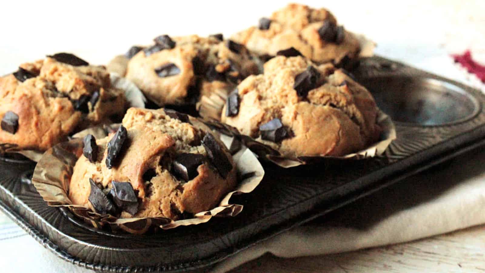 Peanut butter chocolate chip muffins in a muffin tin.
