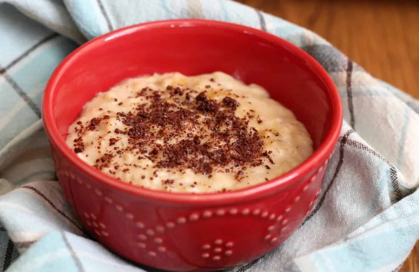 Red bowl of oatmeal on a blue towel.