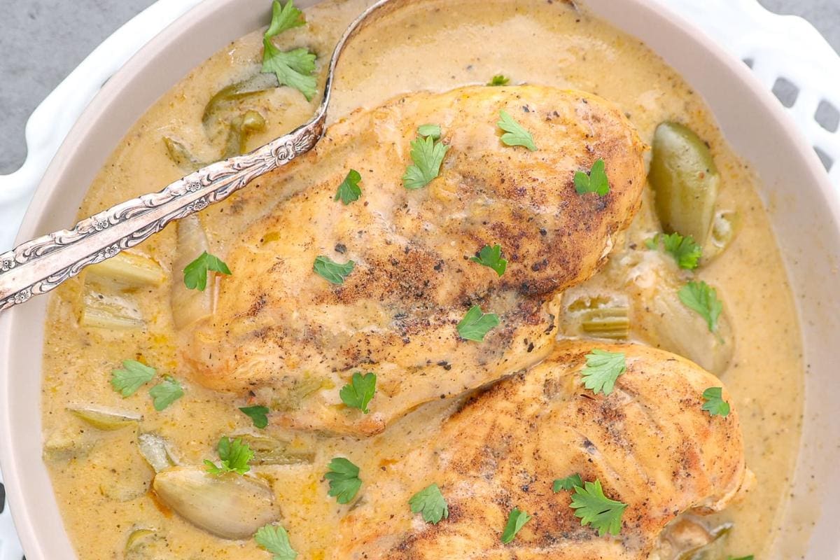 Cajun smothered chicken served with rice and vegetables.