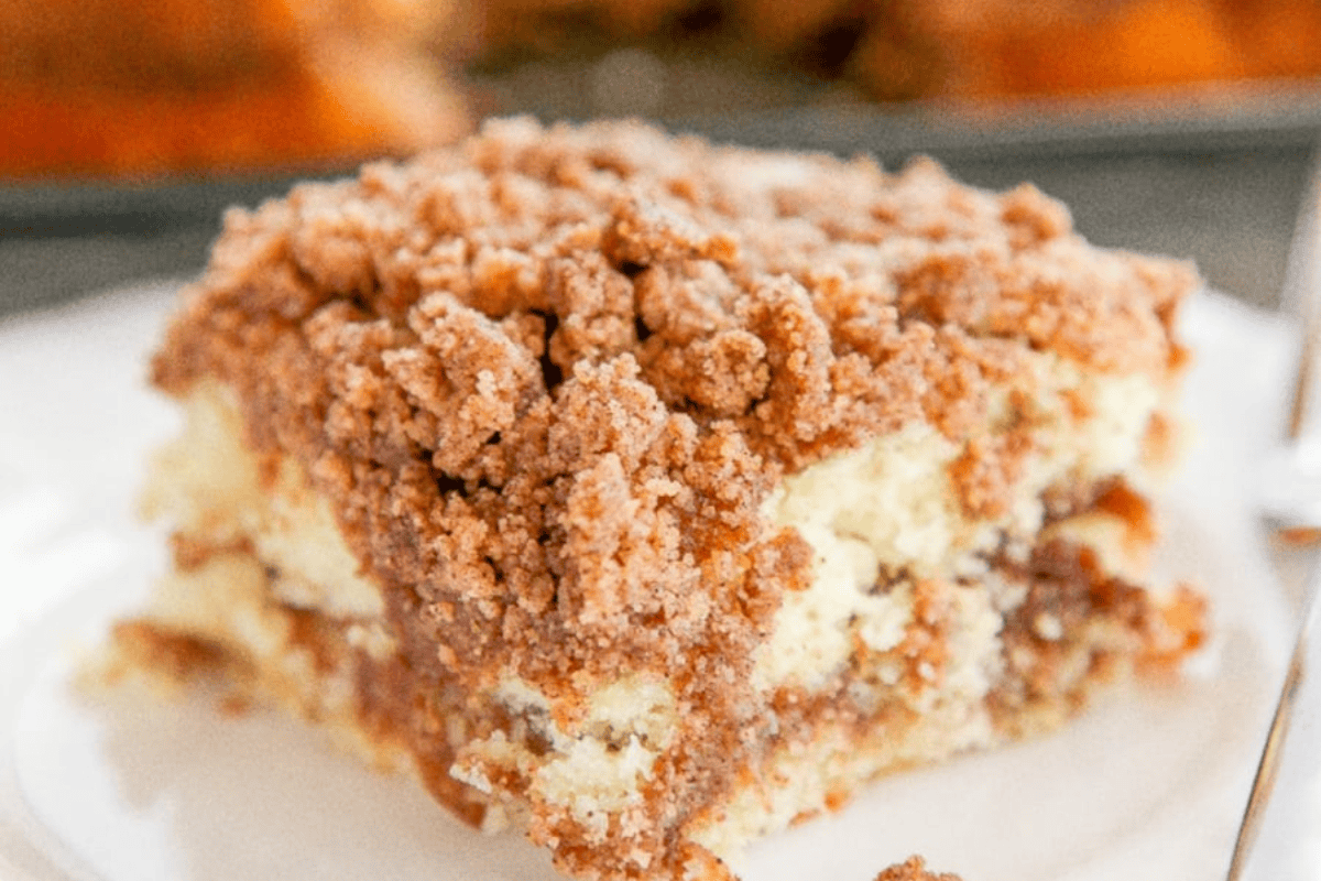 A slice of cinnamon coffee cake topped with brown sugar streusel.