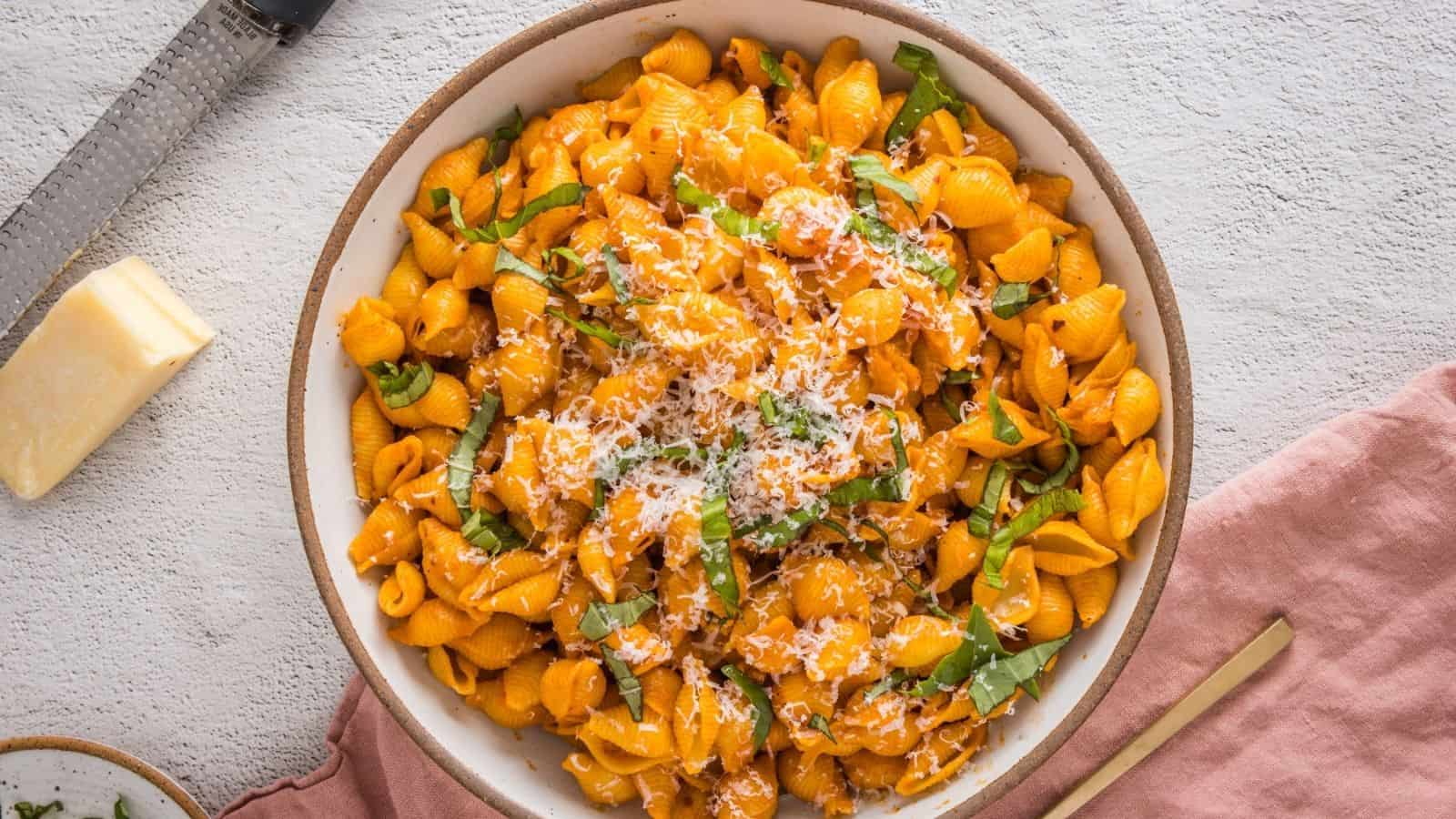 An overhead view of a cooked spicy vodka pasta in a white plate.