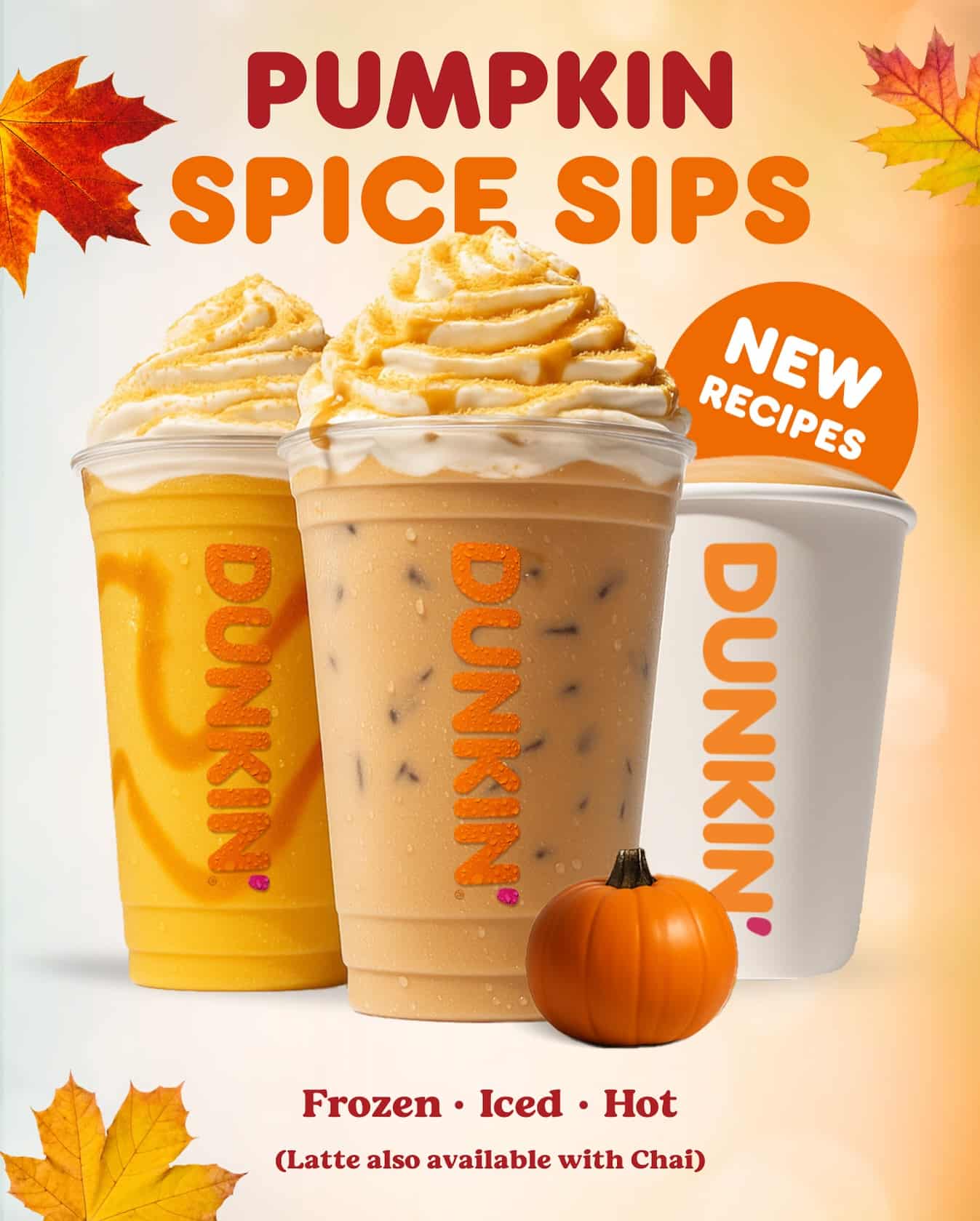 Three Dunkin pumpkin spice drinks in frozen, iced, and hot varieties with whipped cream, seasonal graphics, and a small pumpkin in front. Text highlights new recipes.