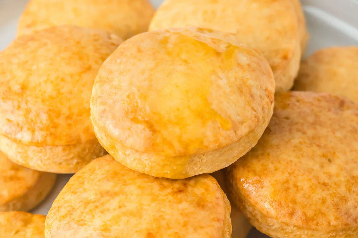 A close-up view of several golden-brown biscuits stacked on top of each other.