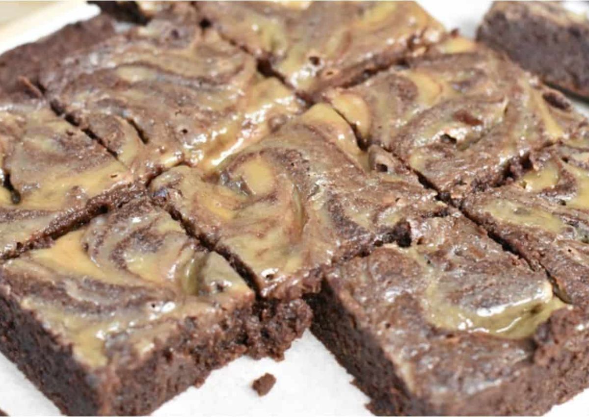 Nine chocolate brownies with a light brown swirl pattern on top, arranged in a grid and cut into squares.