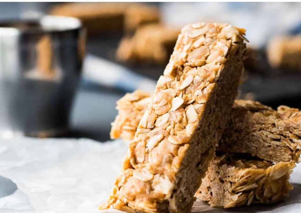 A stack of peanut butter oatmeal bars on a piece of paper.