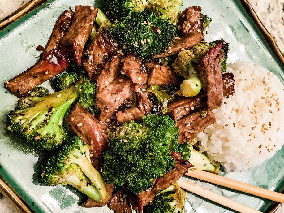 A plate of meat and broccoli.