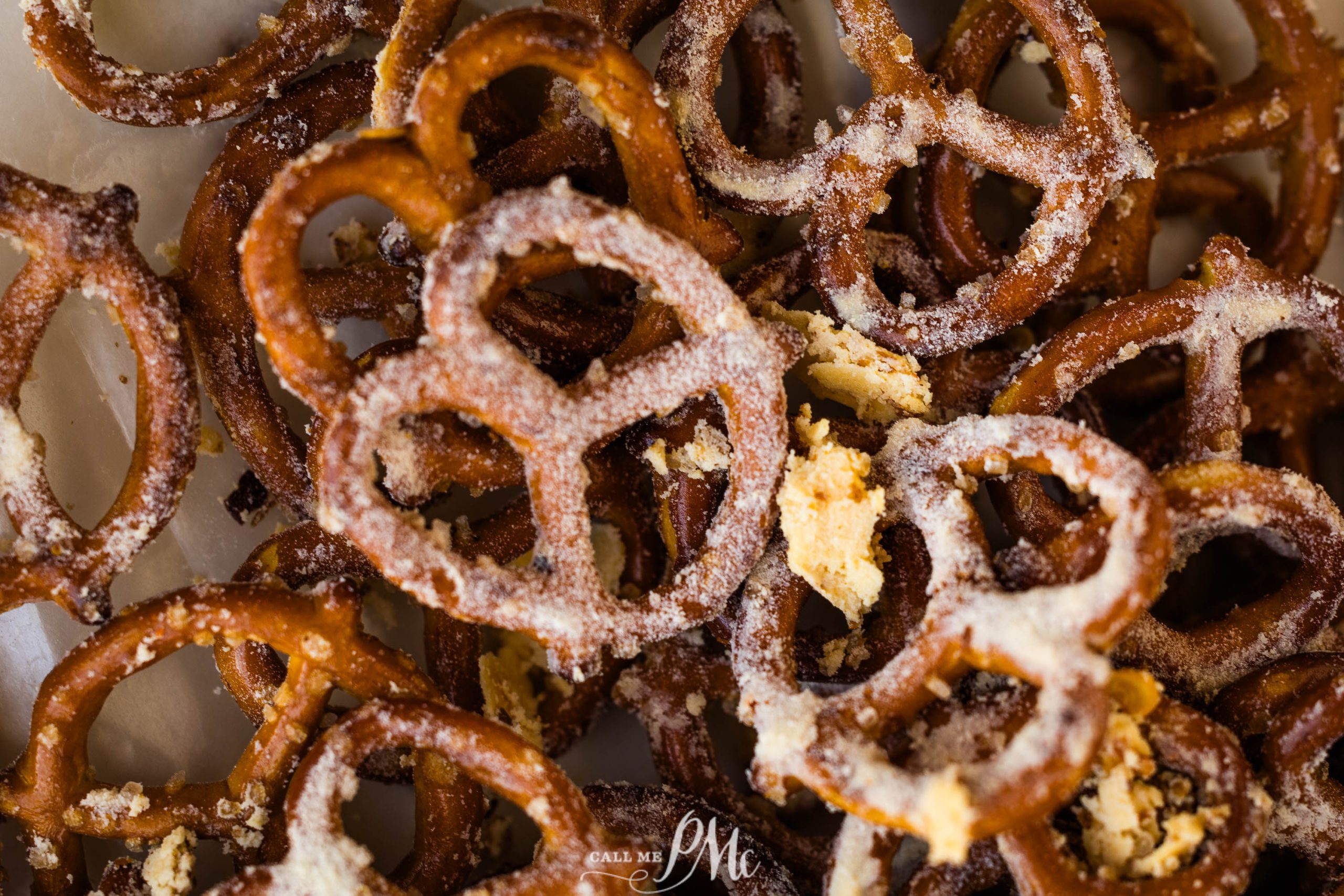 Close-up of salted pretzels with crumbs scattered on and around them.