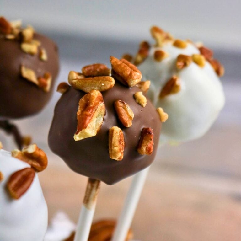 A cake pops with nuts on them.