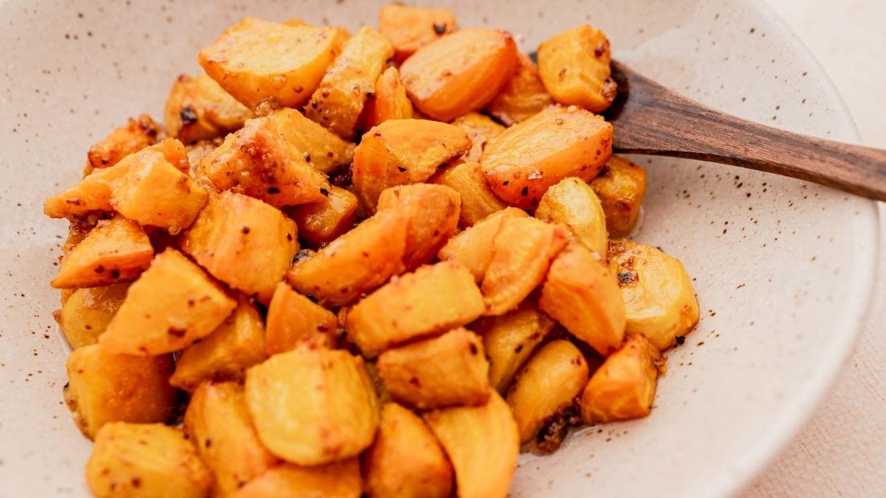 A plate of food with a wooden spoon.