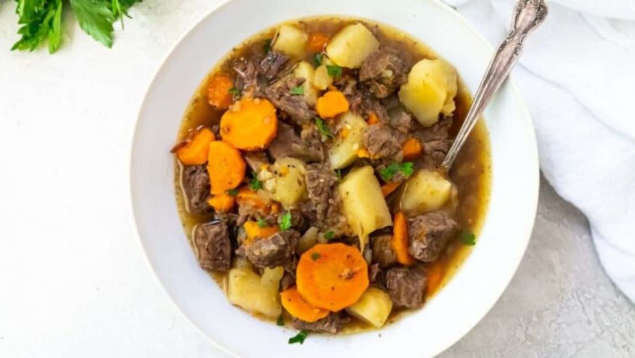 A bowl of stew with meat and vegetables.