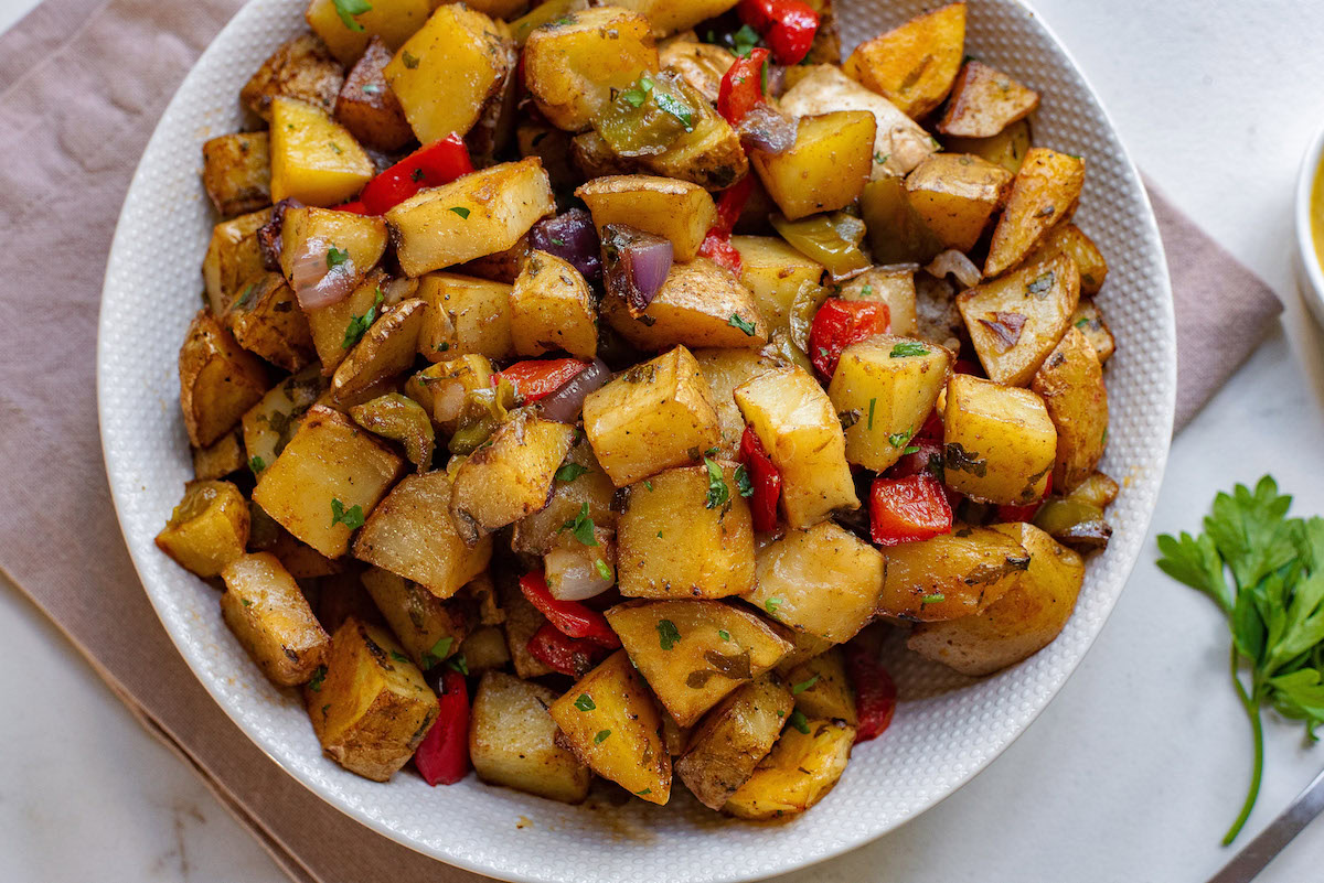 A bowl of potatoes and peppers.