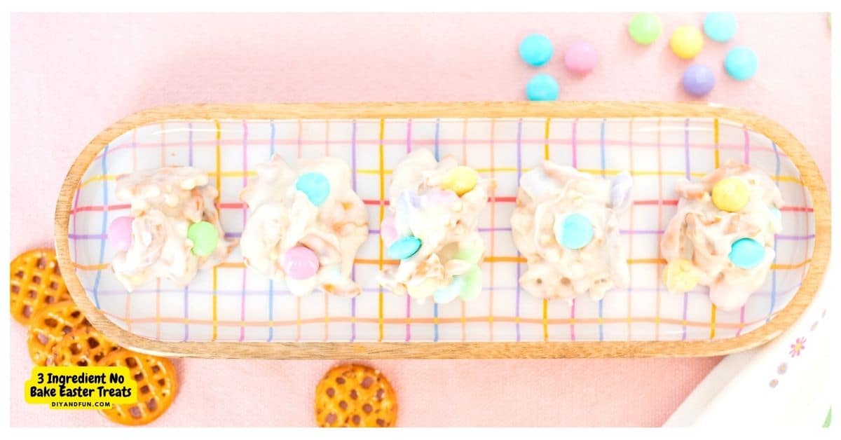 Rectangular plate with five clusters of white chocolate and pastel candies, arranged on a checkered pattern, with pretzels and candies scattered nearby. Text reads 3 Ingredient No Bake Easter Treats.