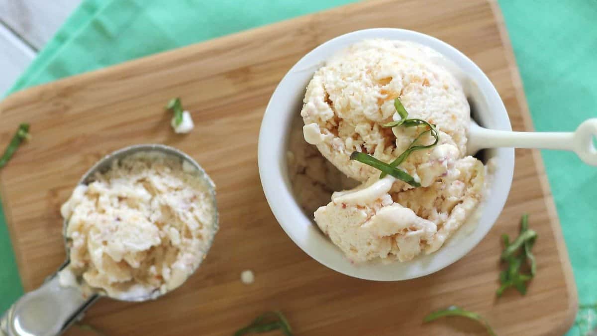 A bowl of ice cream with green garnish.