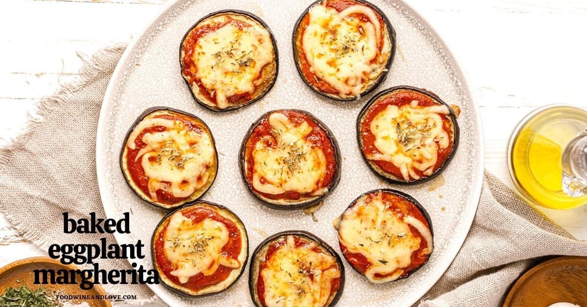 Eight baked eggplant rounds topped with tomato sauce, melted cheese, and herbs are arranged on a white plate with a bottle of olive oil nearby. Text reads baked eggplant margherita.