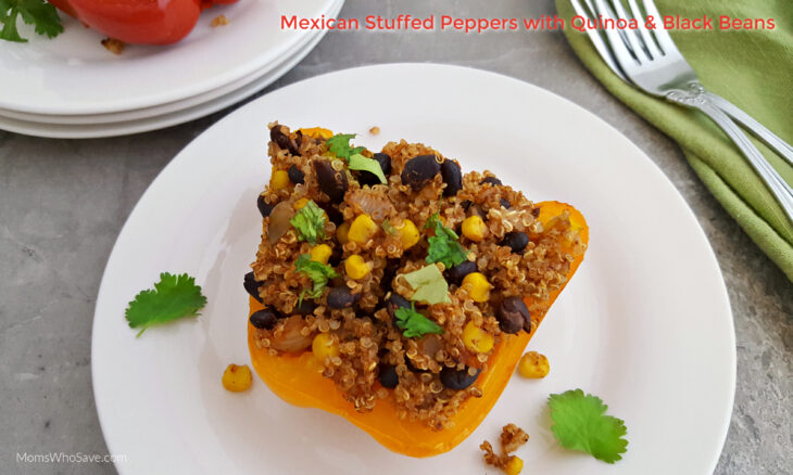 A yellow bell pepper half filled with a mixture of quinoa, black beans, corn, and cilantro on a white plate, with a fork and napkin nearby.