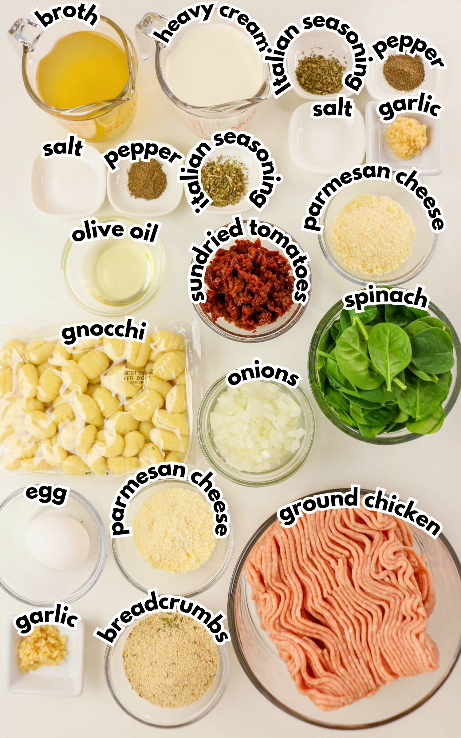 Top-down view of labeled ingredients including broth, heavy cream, seasonings, parmesan cheese, olive oil, sundried tomatoes, spinach, onions, gnocchi, egg, breadcrumbs, garlic, and ground chicken.