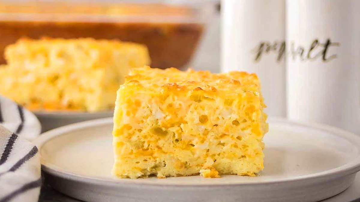 Close-up of several grilled chicken drumsticks with a crispy, seasoned coating, garnished with small bits of fresh herbs.