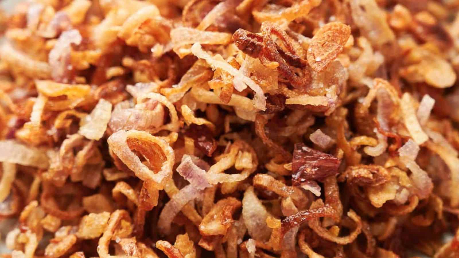 Close-up of crispy fried shallots, showing thin, golden-brown slices with a crunchy texture.