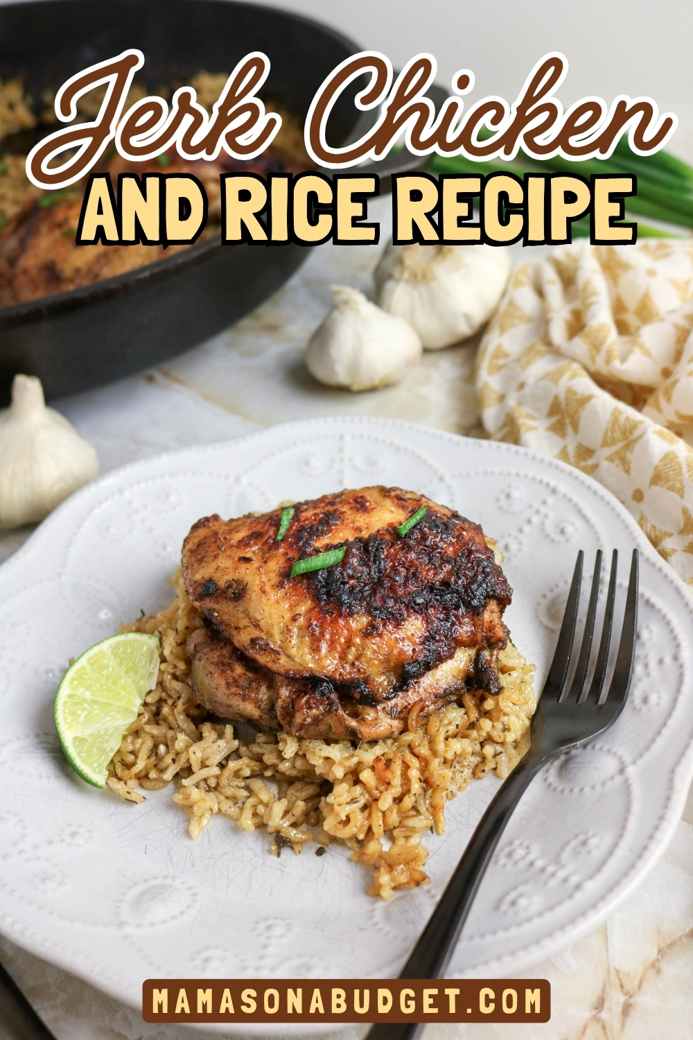 A plate of jerk chicken served on rice with a lime wedge and a fork, displayed on a patterned napkin. Text reads Jerk Chicken and Rice Recipe and mamasonabudget.com.