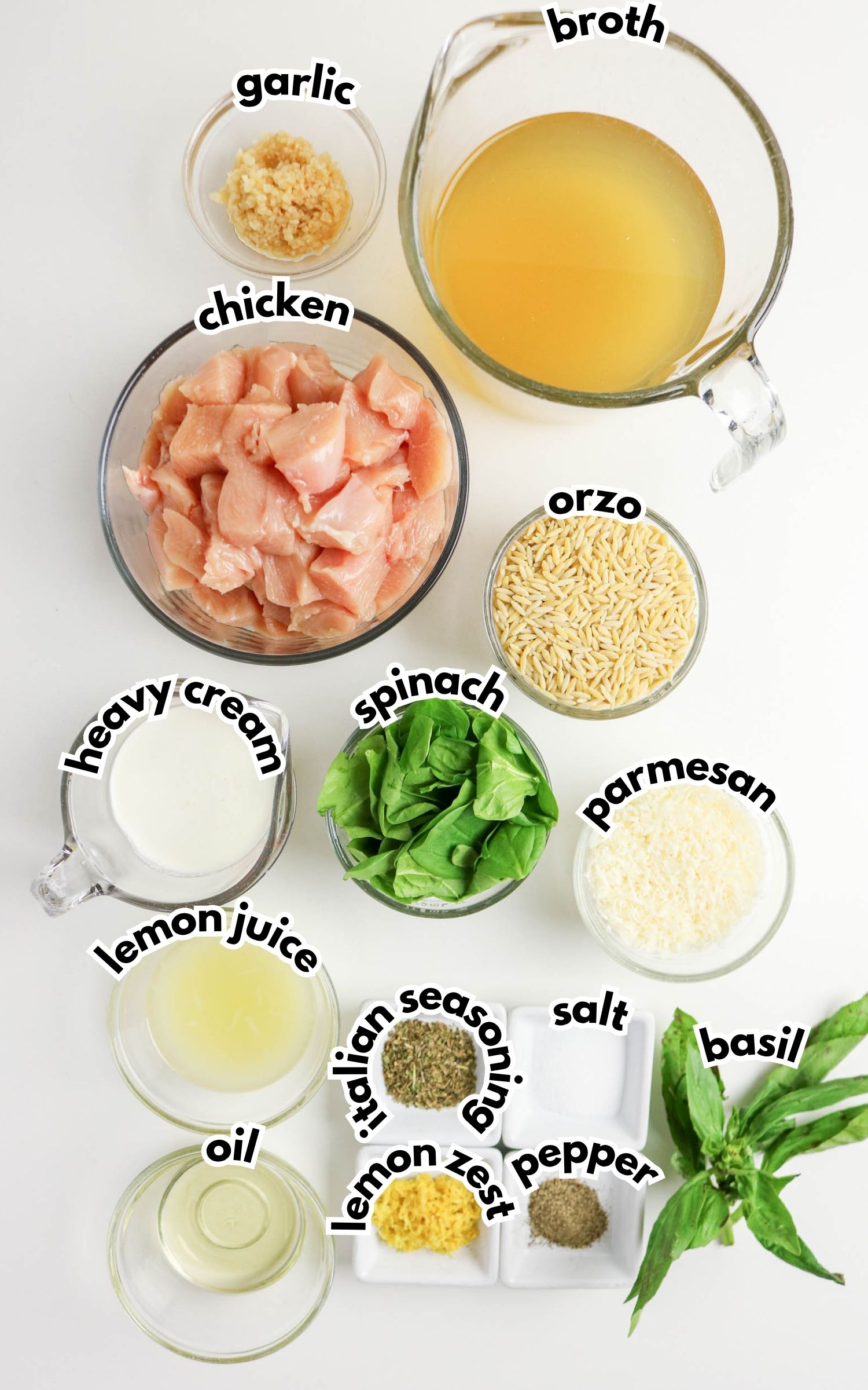 Top-down view of ingredients in bowls: chicken, broth, orzo, spinach, parmesan, garlic, heavy cream, lemon juice, Italian seasoning, salt, pepper, oil, lemon zest, and basil.