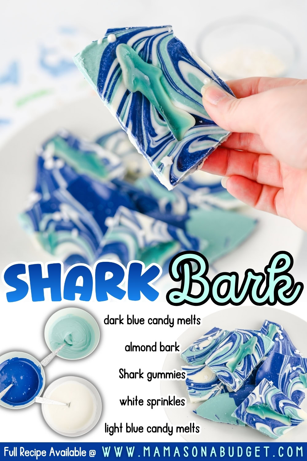 A hand holds a piece of blue and white swirled candy bark with shark gummies, surrounded by more pieces of bark and bowls of melted candy. Ingredients are listed on the image.