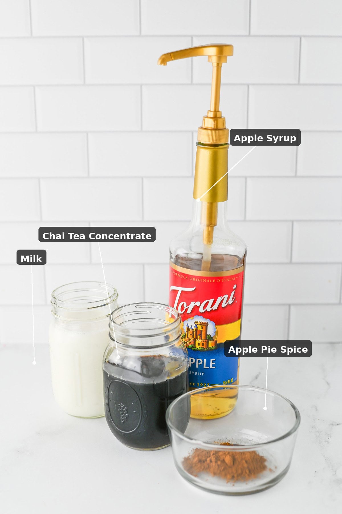 Apple chai latte ingredients: milk, chai tea concentrate, apple syrup, and apple pie spice